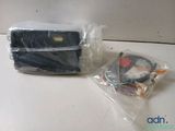 a bag of electronics sitting on a table next to a cell phone