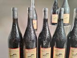 several bottles of wine are lined up on a shelf