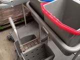 three buckets on a cart in a warehouse