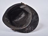 a black hat on a white surface with a white background