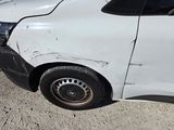 an image of a car that has been damaged and is sitting on the side of the road