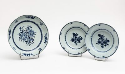 three blue and white plates with floral designs on them on a white surface