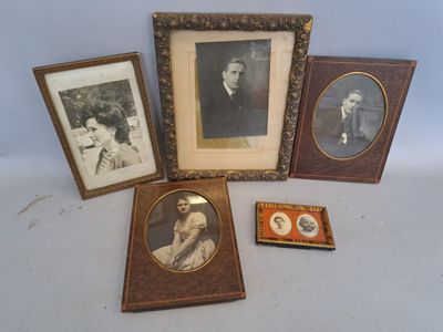 four framed pictures of people and a dog are sitting on a table