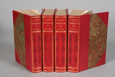 three red books are stacked on top of each other on a table