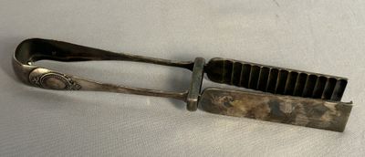 a metal comb and a hair brush on a white surface