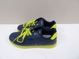 a close up of a pair of blue and yellow shoes on a white surface