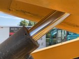 a close up of a large metal pipe on the back of a bulldozer