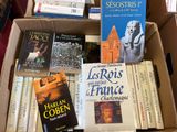 many books in a box on the floor