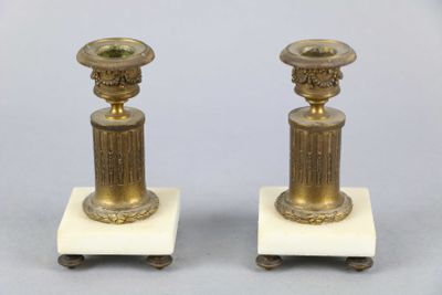 pair of antique brass candlesticks on marble bases