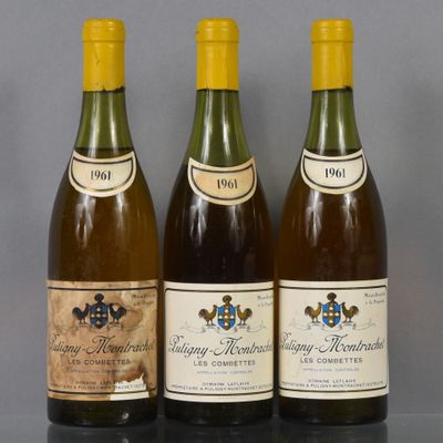 three bottles of wine are lined up on a table