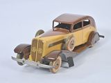 a toy car that is sitting on a white surface
