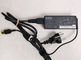 a black laptop charger sitting on top of a white table