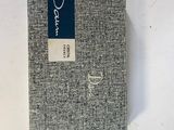 a close up of a book on a white surface with a blue label