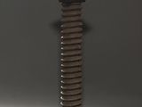 a tall wooden pillar with a black top on a gray background