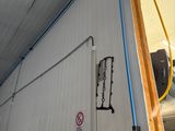 a picture of a room with a door and pipes