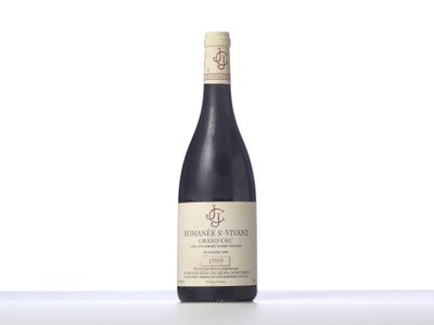 a bottle of wine sitting on top of a white table
