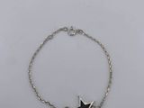 a silver bracelet with a black star on it