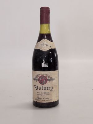 an old bottle of wine sitting on top of a white table