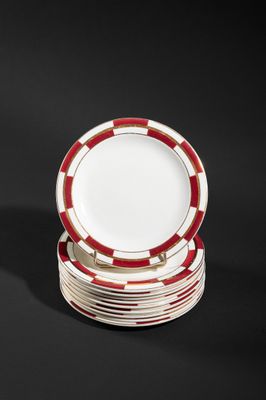 several red and white plates stacked on top of each other on a black surface