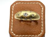 an image of a gold ring sitting on top of a brown leather box