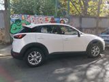 a white car parked in front of a graffiti covered wall