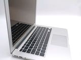 a white laptop with a black keyboard on a white surface