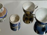 many cups and saucers sitting on a table
