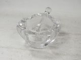a clear glass bowl with a spoon inside of it
