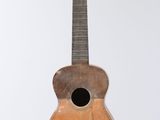 a small wooden guitar hanging from the ceiling