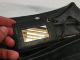 a person holding a wallet with a mirror in it