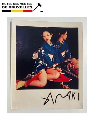 a picture of two women in kimono robes sitting on a bed