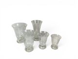 a group of glass vases sitting on a white surface