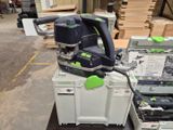 a green and black orbital sander sitting on top of a white box