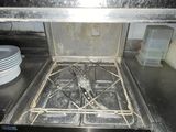 a dirty stove top in a kitchen with dirty dishes on the counter