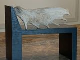 a wooden bench with a piece of wood on top of it