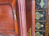 a wooden cabinet with a mirror on top of it