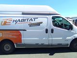 a white van that is parked in a parking lot