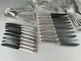 a lot of silver spoons and forks on the table