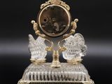 a clock that is sitting on top of a glass stand