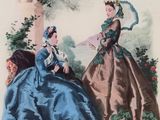 two women in blue dresses sitting on a bench in front of a tree