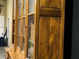a tall wooden cabinet in the middle of a room