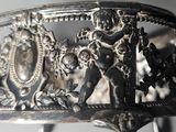 a close up of a silver bracelet with a design on it
