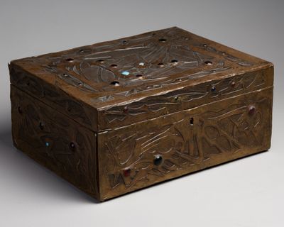 an old wooden box with a design on the lid