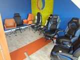 a room with a lot of chairs and a wall with a logo