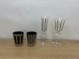 three wine glasses sitting on a table next to each other