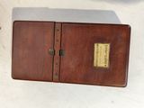 a small wooden box that has a label on it