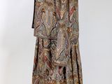 an image of a dress and jacket on a mannequin stand