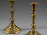 pair of antique brass candlesticks on a grey background