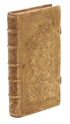 an old book sitting on top of a white surface next to a white background