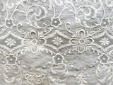 an image of a close up of a white lace on a table cloth